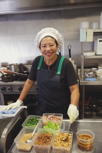 Asian female chef in commercial kitchen