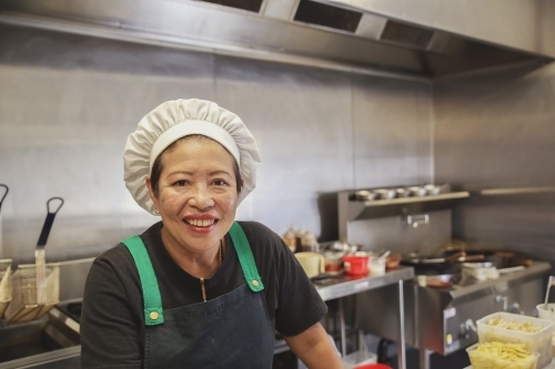Asian woman chef portrait, small business thai restaurant