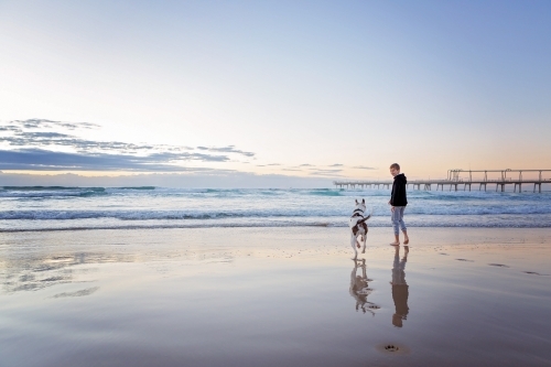 Beach reflections with boy & Dog