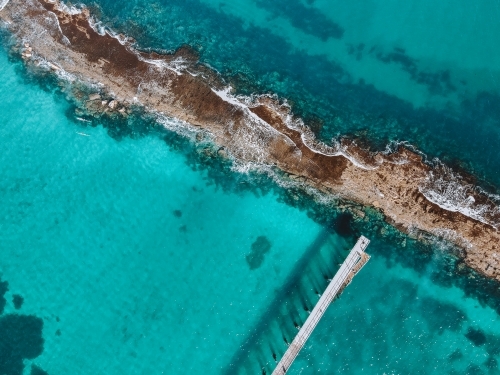 Beach with reef and jetty from above