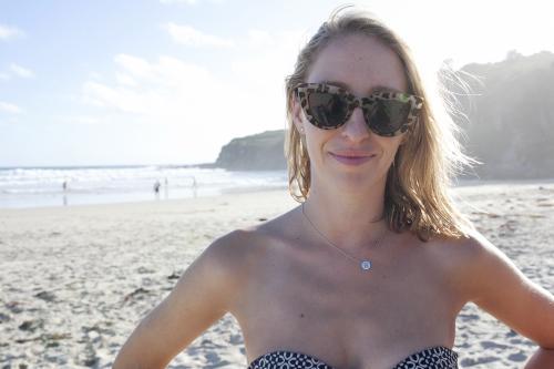 Blonde woman with sunglasses on at beach