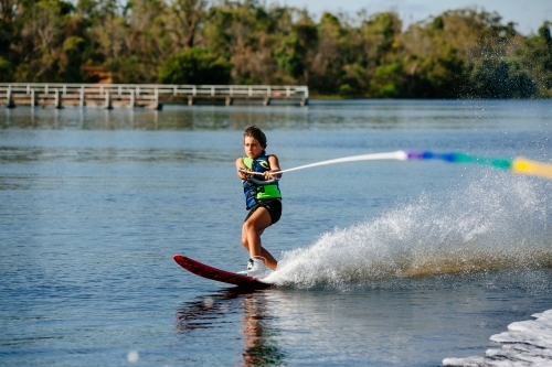Boy water skiing on lake