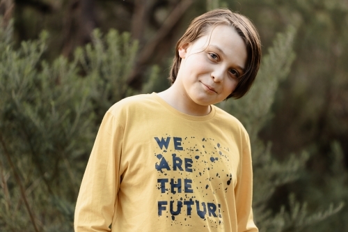 Boy wearing a generic yellow T-shirt that says we are the future