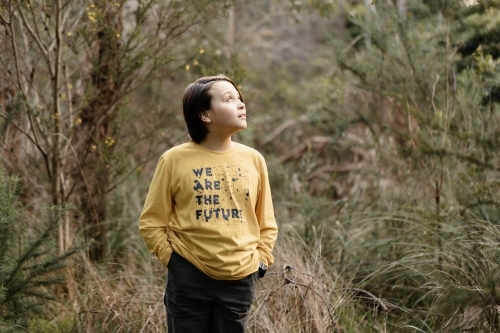 Boy wearing a generic yellow T-shirt that says we are the future