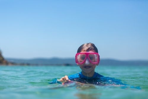Boy with Snorkel Goggles in clean blue water