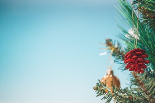 Christmas tree and baubles on the beach background. Out of focus background of aqua blue beach