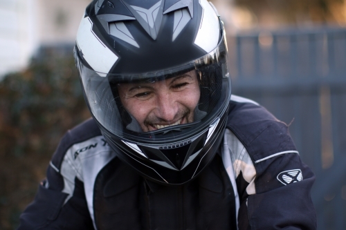 Close up of man wearing a motorbike helmet