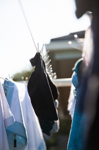 Clothes hanging on a washing line with eco friendly metal pegs
