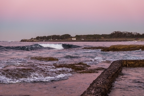 Coastal scene with waves at dusk