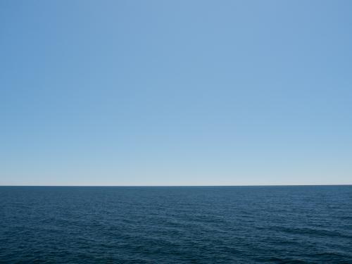 Deep blue ocean with pale blue sky