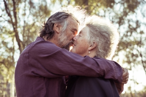 Elderly couple hug together