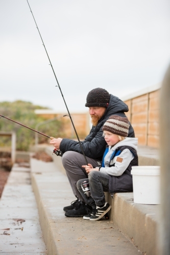Father and Son fishing in winter