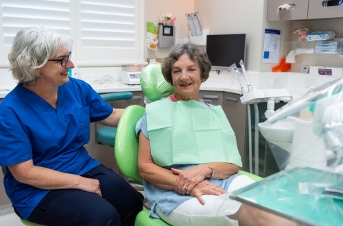 Female dentist with elderly female patient