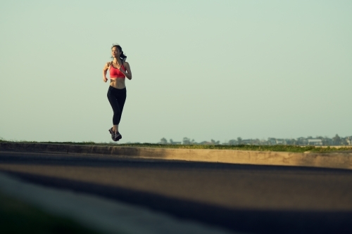 Fit Asian woman running for morning exercise