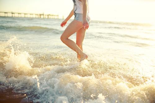 Girl splashing on a beach