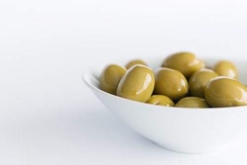 Green Olives In A Bowl on white