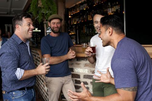 Group of mates having a drink at local craft beer bar