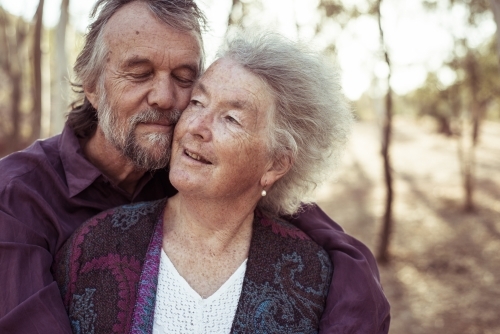 Happy elderly couple hug