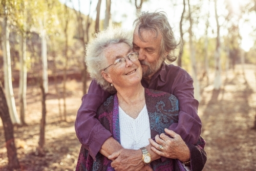 Happy elderly couple hug in the Northern Territory
