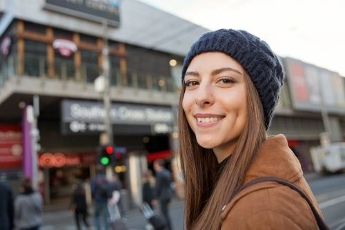 Happy woman walking through Melbourne city
