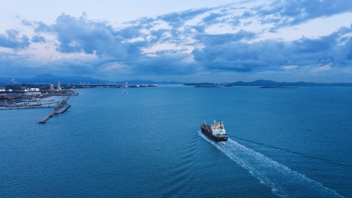 Horizontal shot of a port and a ship sailing