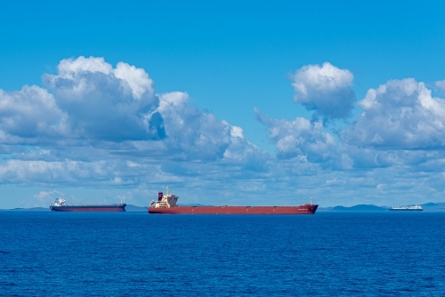 Horizontal shot of cargo ships in the sea