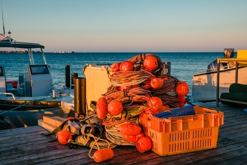 Horizontal shot of commercial crayfishing buoys on a jetty.