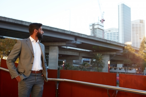 Indian businessman with open collar cheerful outdoors in city