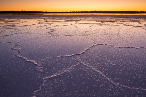 Irregular patterns on a salt lake at dawn