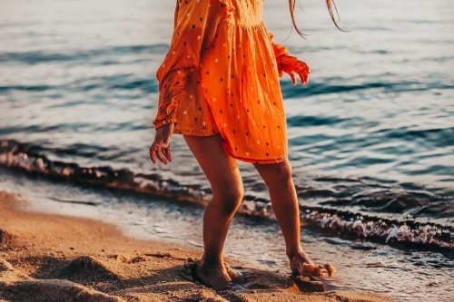 Little girl at the beach and waves