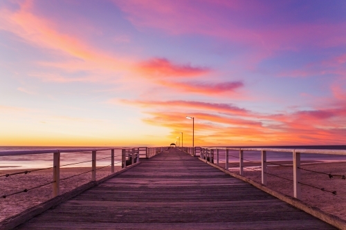 Looking along a jetty at sunset