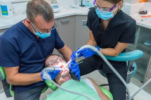 Man having teeth cleaned at dentist