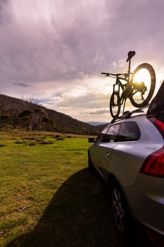 Mountain bike and SUV at sunset at Dead Horse Gap