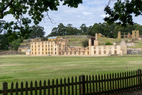 Penitentiary at Port Arthur framed by picket fence and trees