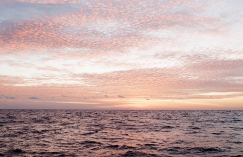 Pink Sunset over rippled ocean