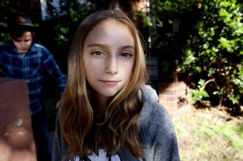 Portrait of teenager looking at camera in garden outside