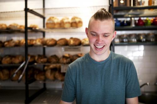 Portrait of young man working at cafe