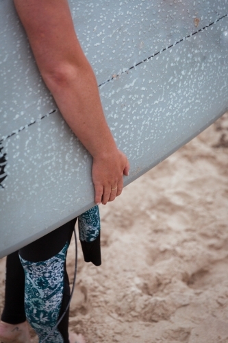 Preparing to Surf with waxed surfboard