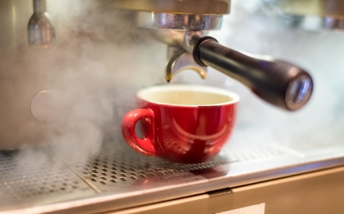 Red coffee cup on coffee machine