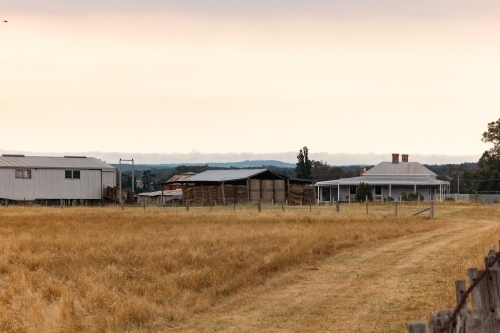 Rural farm with old style farm house, hay and shearing shed in Country Victoria