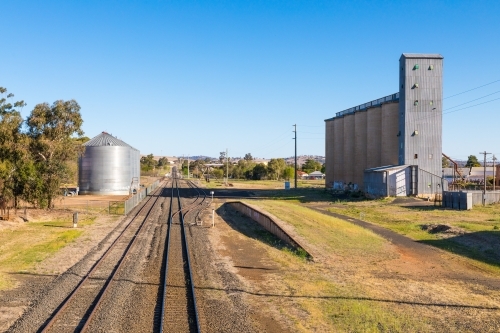 Rural industrial scene with railway lines, rail siding and factory silos