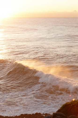 Seascape and large wave at sunrise