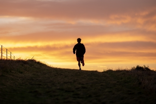 Silhouette of Man Running at Sunrise