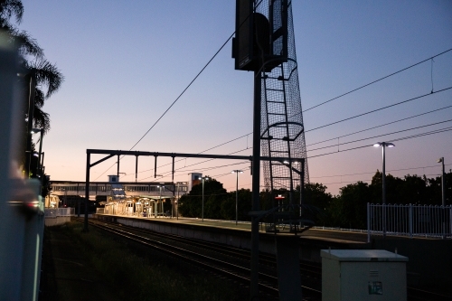 suburban Brisbane train station at dusk