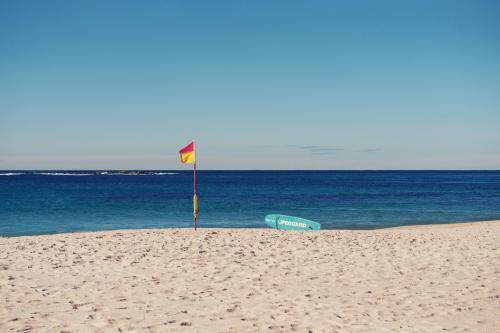 Surf lifesaving flag and paddleboard on Coogee, Sydney