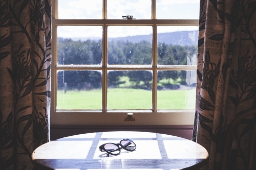 Table in front of window overlooking country landscape