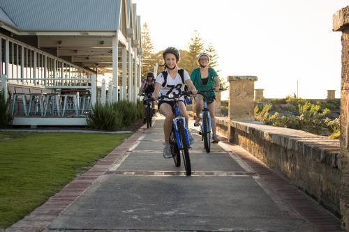 Teen girls cycling on concrete path on Busselton foreshore