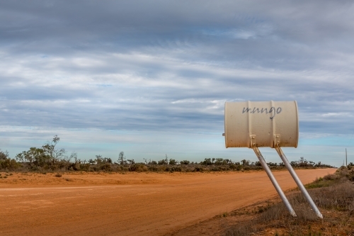 The road and signage at Mungo National Park in the NSW outback desolate desert landscape