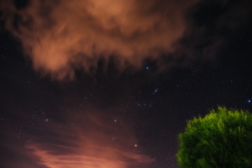 The sky at night with peach clouds