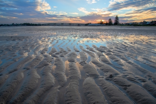 Tidal sand flat at sunset with sand ripples